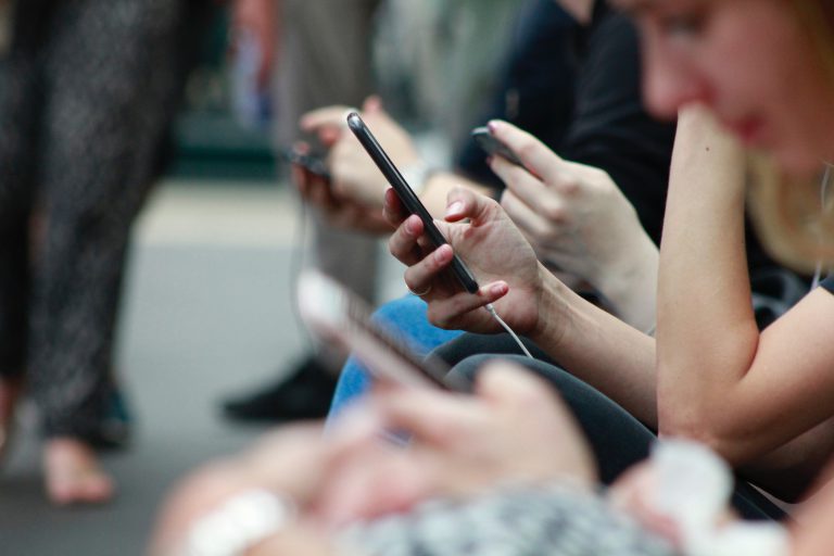People looking at mobile in subway
